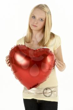 Royalty Free Photo of a Girl With a Heart Balloon
