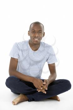 Royalty Free Photo of a Teenage Boy Sitting on the Floor