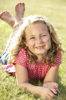 Royalty Free Photo of a Little Girl Lying on the Grass