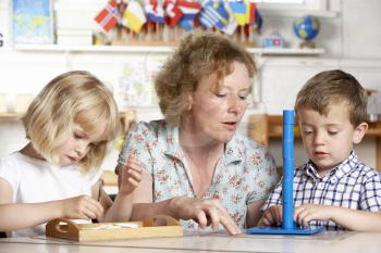 Royalty Free Photo of an Adult With Two Preschoolers