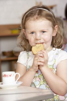 Royalty Free Photo of a Little Girl Having Tea in Preschool