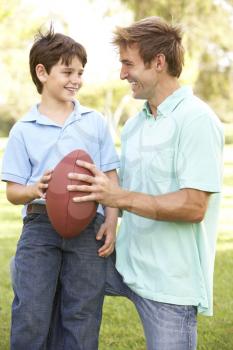 Royalty Free Photo of a Father and Son With a Football