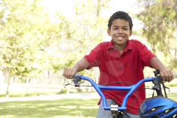 Boy Riding Bike In Park