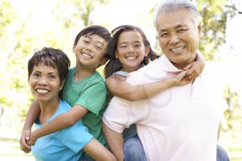 Portrait Of Grandparents With Grandchildren In Park