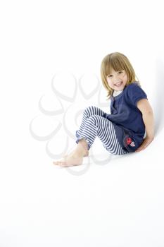 Young Girl Sitting In WhiteStudio