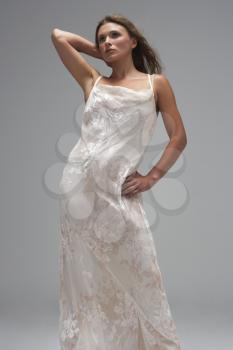 Full Length Studio Shot Of Young Woman In White Evening Dress