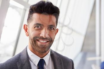 Portrait Of Hispanic Businessman In Modern Office