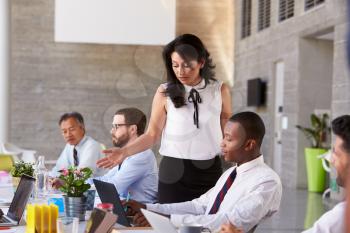 Businesswoman Working With Colleagues At Boardroom Table