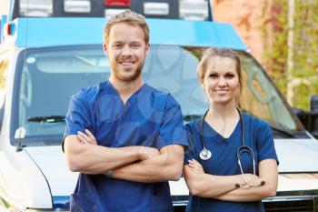 Portrait Of Medical Staff Standing In Front Of Ambulance