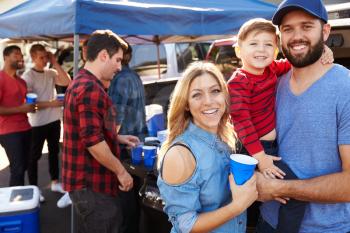 Portrait Of Family Group Tailgating In Stadium Car Park
