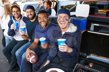 Group Of Sports Fans Tailgating In Stadium Car Park