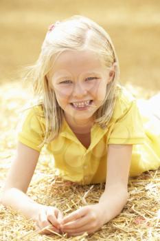 Portrait Of Girl Laying In Summer Harvested Field