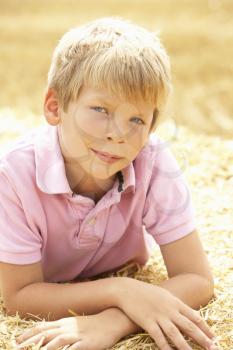 Portrait Of Boy Laying In Summer Harvested Field