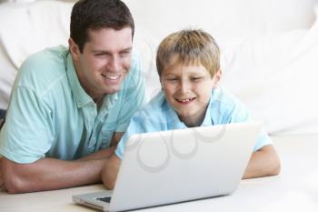 Young man with child on laptop computer