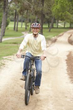 Senior man riding bicycle in park