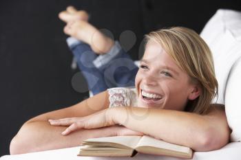 Studio Portrait Of Teenage Girl Reading Book