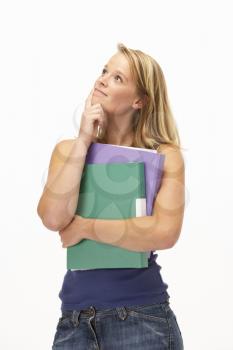 Studio Portrait Of Female Student Holding Folders