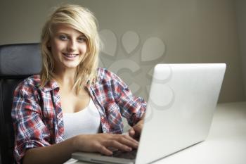 Teenage Girl Using Laptop At Home