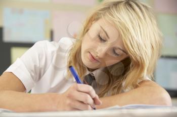 Female Teenage Student Studying In Classroom