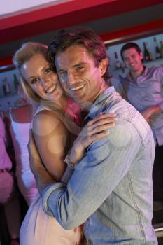 Couple Having Fun In Busy Bar