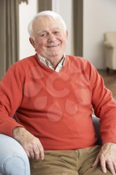 Senior Man Relaxing In Chair At Home