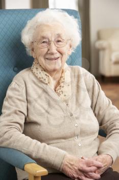 Senior Woman Relaxing In Chair At Home