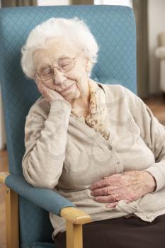 Senior Woman Resting In Chair At Home