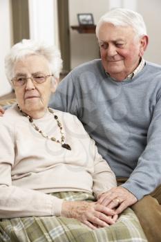 Senior Man Consoling Wife At Home