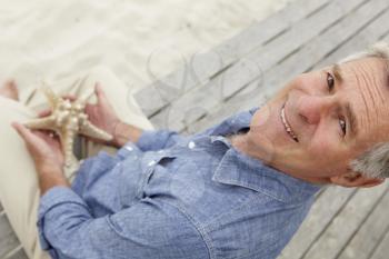 Senior man holding starfish