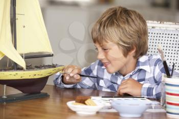 Young boy making model ship