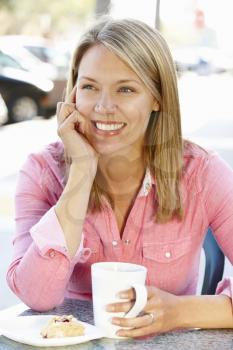 Woman sitting at sidewalk caf