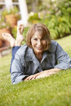 Mid age woman relaxing in garden
