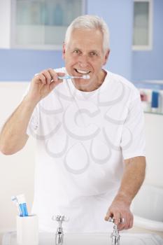 Senior man brushing teeth