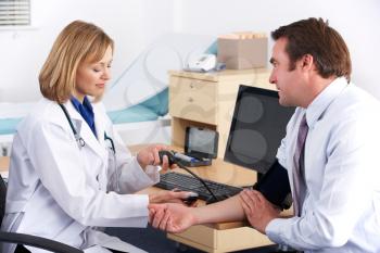 American doctor taking patient's blood pressure
