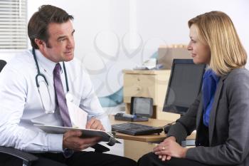 American doctor talking to businesswoman patient
