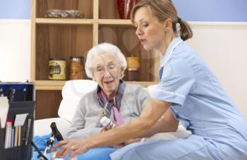 UK nurse visiting senior woman at home