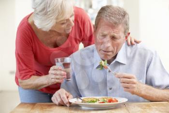 Senior woman looking after sick husband