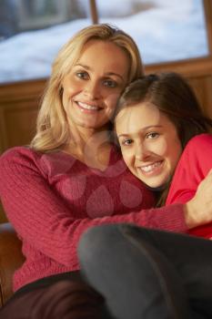 Portrait Of Mother And Daughter Relaxing On Sofa Together