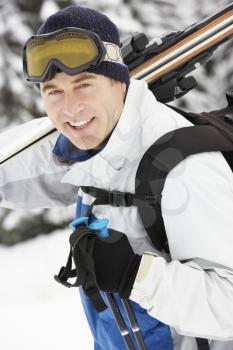 Middle Aged Man On Ski Holiday In Mountains