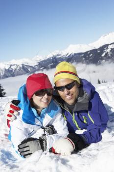 Couple Having Fun On Ski Holiday In Mountains