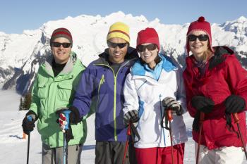 Group Of Middle Aged Couples On Ski Holiday In Mountains