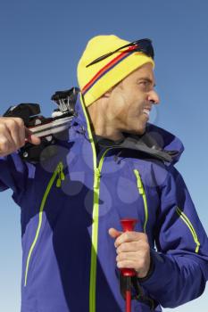 Middle Aged Man On Ski Holiday In Mountains