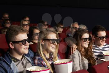 Group Of Teenage Friends Watching 3D Film In Cinema