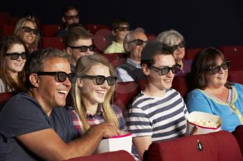 Teenage Family Watching 3D Film In Cinema