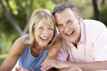 Senior Couple Relaxing In Summer Garden