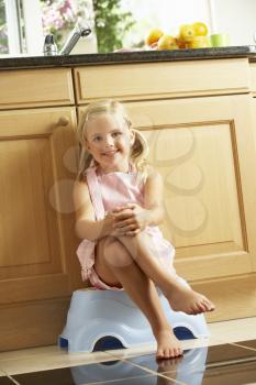 Girl Sitting On Plastic Step In Kitchen