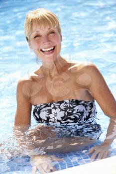 Senior Woman Having Fun In Swimming Pool