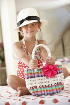 Girl Wearing Swimming Costume With Straw Hat And Bag