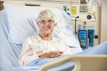 Portrait Of Senior Female Patient Relaxing In Hospital Bed