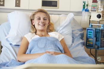 Teenage Female Patient Relaxing In Hospital Bed